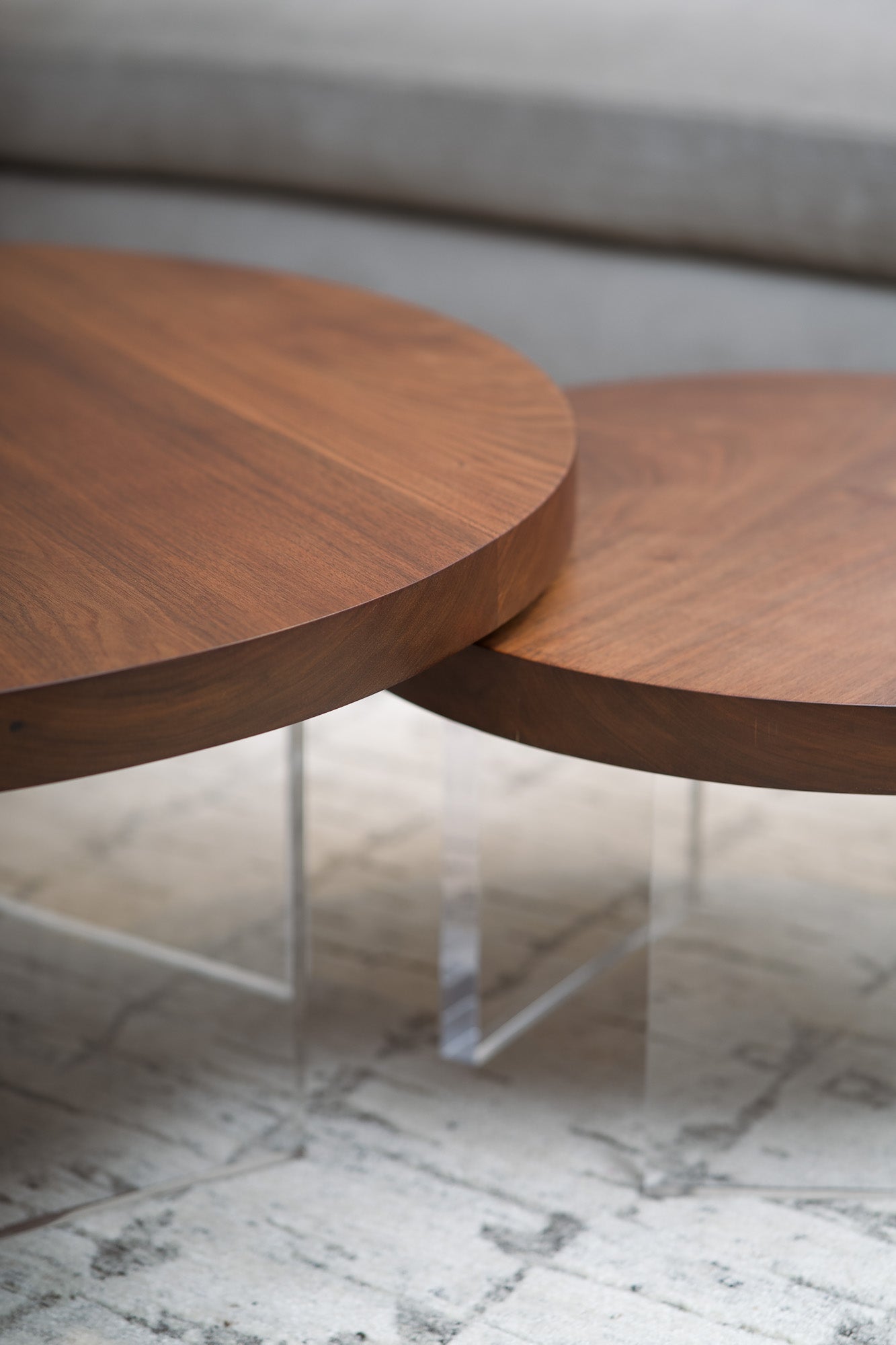 Modern coffee table—solid wood with sculptural blackened steel or acrylic base, designed in British Columbia