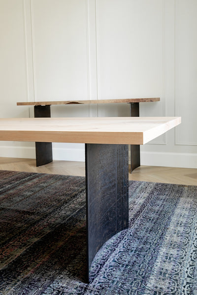 End View of Modern Ban Dining Table with Curved Steel Legs and Ban Console in Background